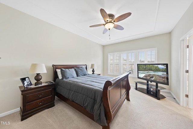 bedroom with baseboards, light colored carpet, and a ceiling fan