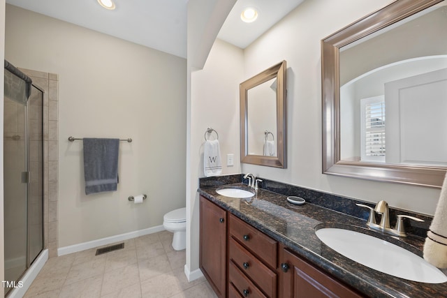 bathroom featuring visible vents, a stall shower, baseboards, and a sink