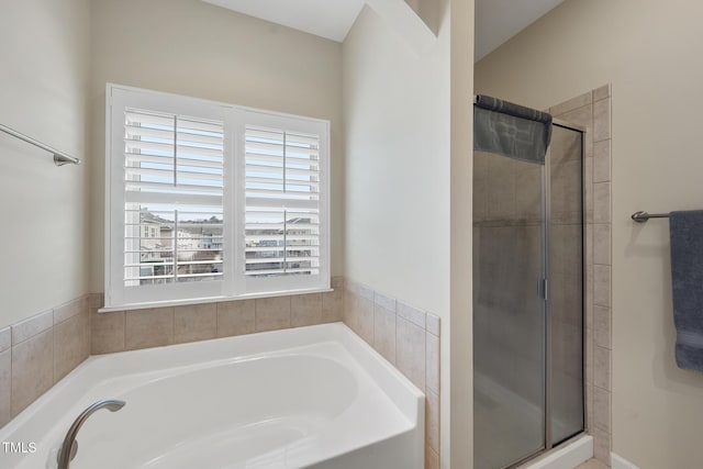 full bath featuring a shower stall and a bath