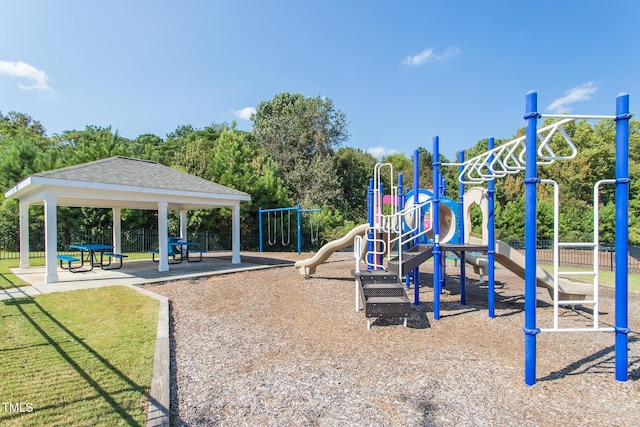 communal playground with a gazebo, a yard, and fence