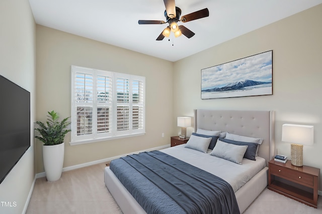 carpeted bedroom featuring baseboards and ceiling fan