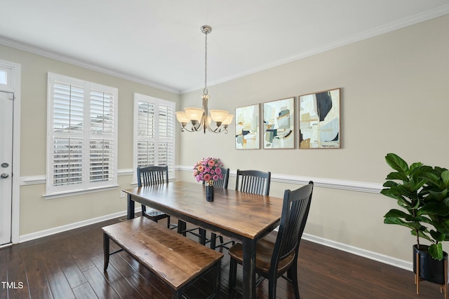 dining room with a chandelier, ornamental molding, baseboards, and hardwood / wood-style flooring