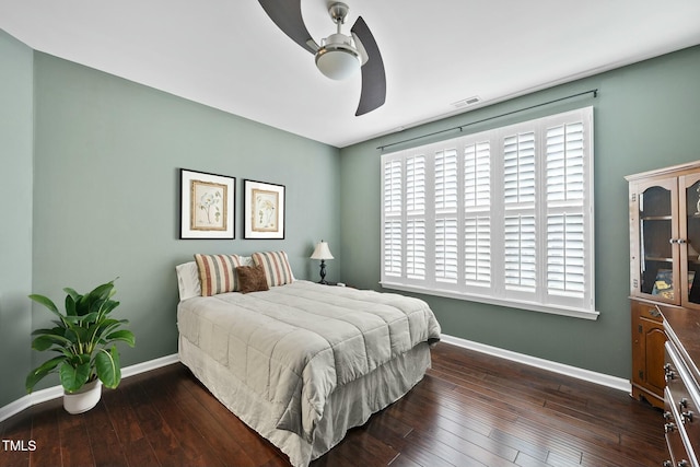 bedroom featuring visible vents, ceiling fan, baseboards, and hardwood / wood-style flooring