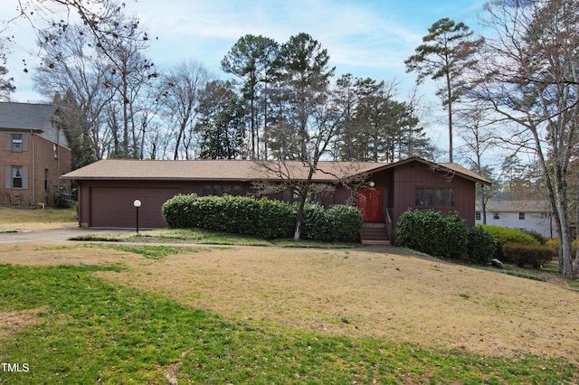 ranch-style home with a garage, driveway, and a front yard