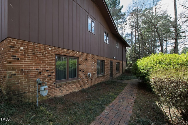 view of side of property with brick siding