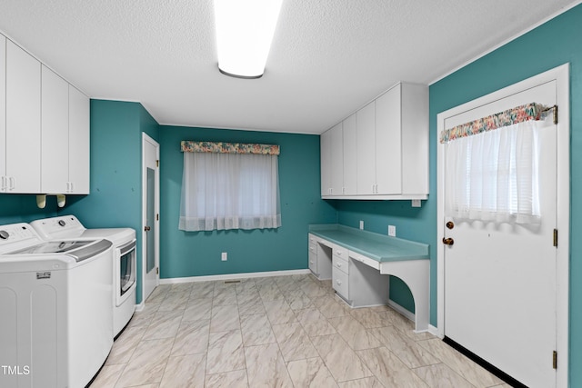 laundry room with baseboards, cabinet space, separate washer and dryer, a textured ceiling, and marble finish floor