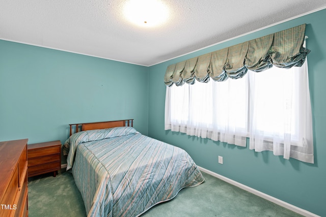 carpeted bedroom featuring baseboards and a textured ceiling