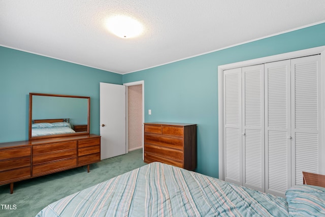 carpeted bedroom with a closet and a textured ceiling