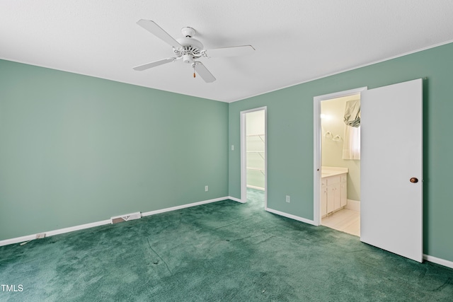 unfurnished bedroom with visible vents, baseboards, carpet, and a spacious closet