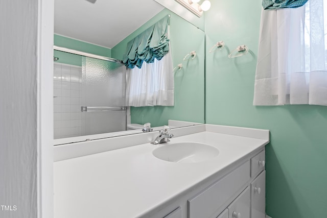 bathroom featuring vanity and a shower with shower door