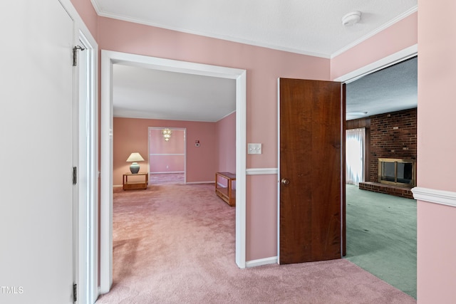 corridor with crown molding, carpet flooring, and baseboards