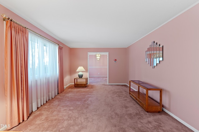 sitting room featuring light colored carpet and baseboards