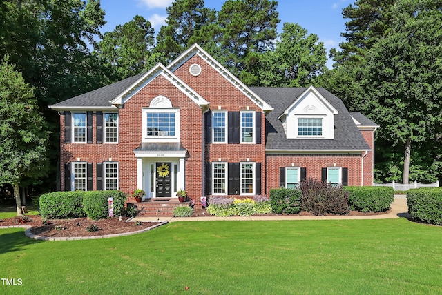 2514 Mcgowan Ct, Wake Forest, NC 27587 - georgian-style home featuring brick siding, a front lawn, and roof with shingles