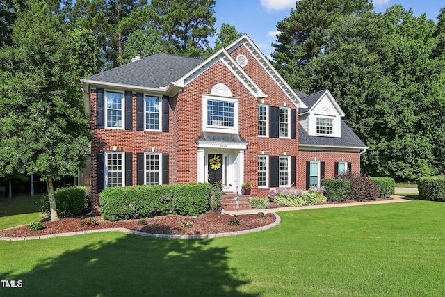 2514 Mcgowan Ct, Wake Forest, NC 27587 - colonial home featuring brick siding, a front lawn, and a shingled roof