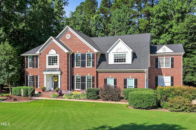 2514 Mcgowan Ct, Wake Forest, NC 27587 - colonial home with brick siding, a front yard, and a shingled roof