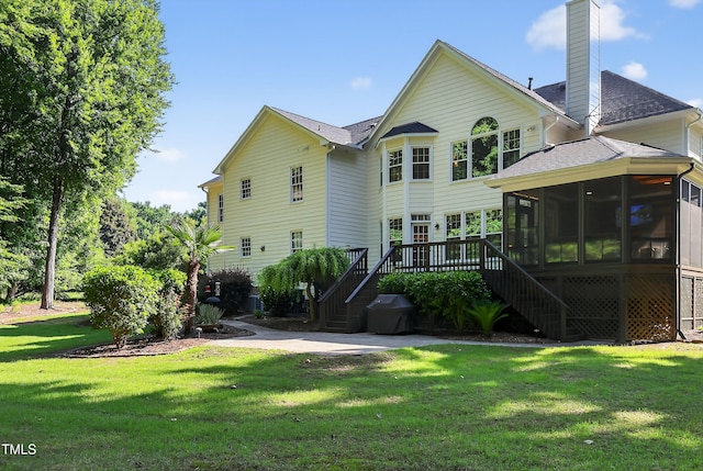2514 Mcgowan Ct, Wake Forest, NC 27587 - back of house with stairway, a sunroom, a chimney, a shingled roof, and a yard