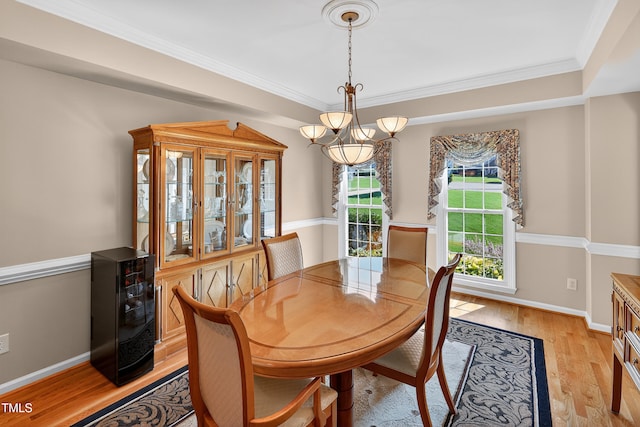 2514 Mcgowan Ct, Wake Forest, NC 27587 - dining area with a chandelier, light wood-style floors, and ornamental molding