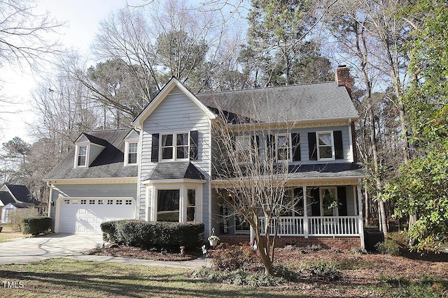 view of front facade with a shingled roof, a porch, concrete driveway, a chimney, and a garage