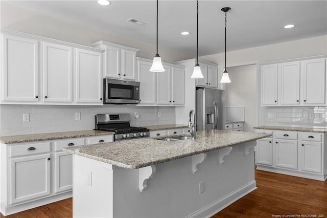 kitchen featuring a sink, appliances with stainless steel finishes, and white cabinets