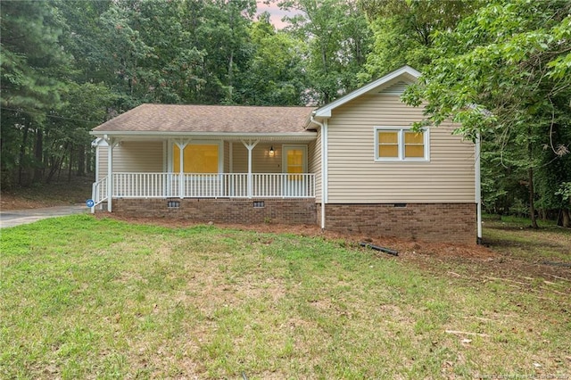 single story home with covered porch and a front lawn