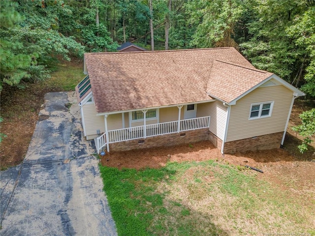 view of front of house featuring roof with shingles and a porch