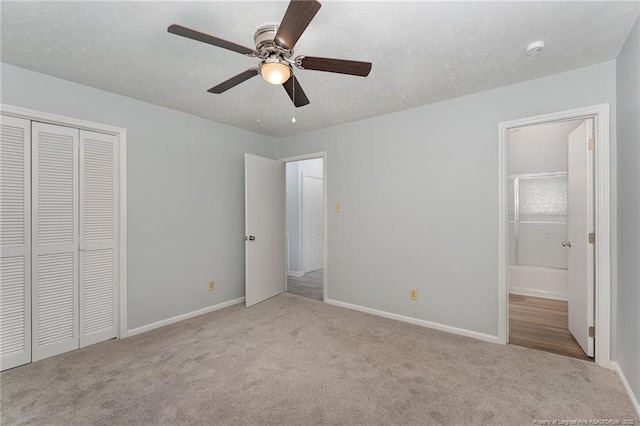 unfurnished bedroom featuring a closet, baseboards, carpet, and a textured ceiling