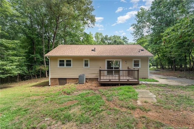 rear view of house with a lawn and a deck