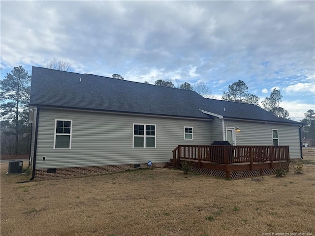 back of house with central AC, roof with shingles, a lawn, a deck, and crawl space