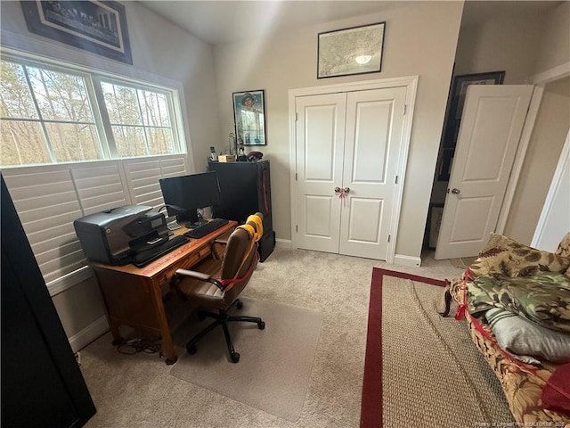 home office with light carpet and baseboards