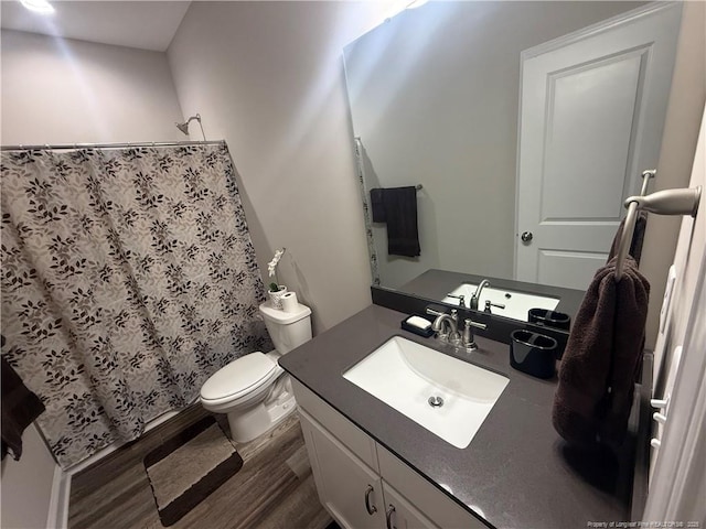 full bath featuring toilet, vanity, a shower with curtain, and wood finished floors