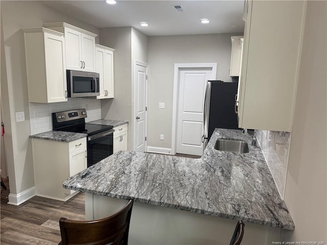 kitchen featuring visible vents, stone counters, and appliances with stainless steel finishes