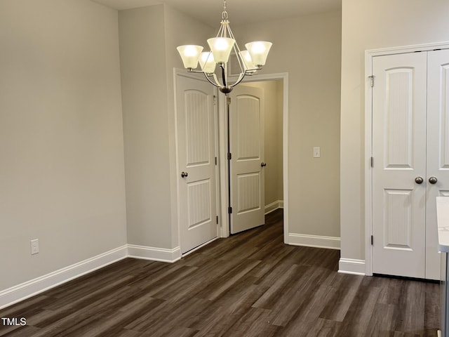 1794 Parham Dr, Graham, NC 27253 - unfurnished dining area with dark wood-style floors, baseboards, and a chandelier