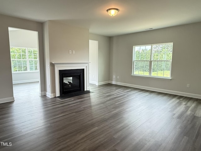 1794 Parham Dr, Graham, NC 27253 - unfurnished living room featuring dark wood finished floors, baseboards, and a fireplace with flush hearth