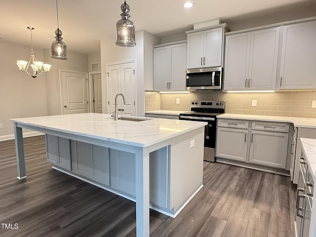 1794 Parham Dr, Graham, NC 27253 - kitchen with appliances with stainless steel finishes, a sink, dark wood-style floors, decorative backsplash, and recessed lighting