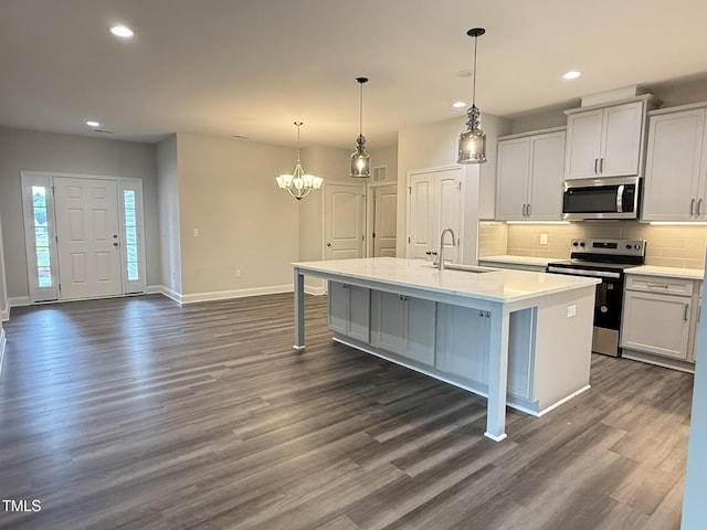 1794 Parham Dr, Graham, NC 27253 - kitchen with appliances with stainless steel finishes, a sink, baseboards, a chandelier, and backsplash