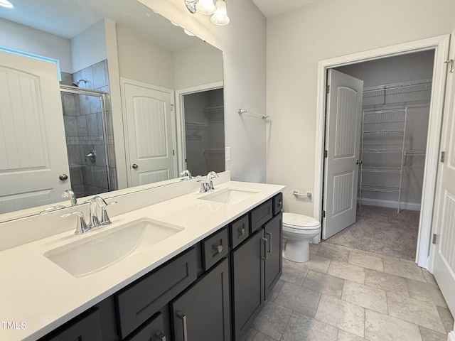 1794 Parham Dr, Graham, NC 27253 - bathroom featuring a shower stall, toilet, double vanity, and a spacious closet