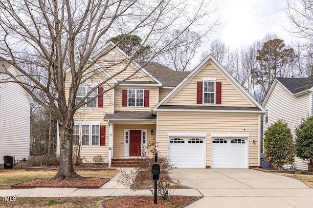 view of front of property with a garage, concrete driveway, and a shingled roof