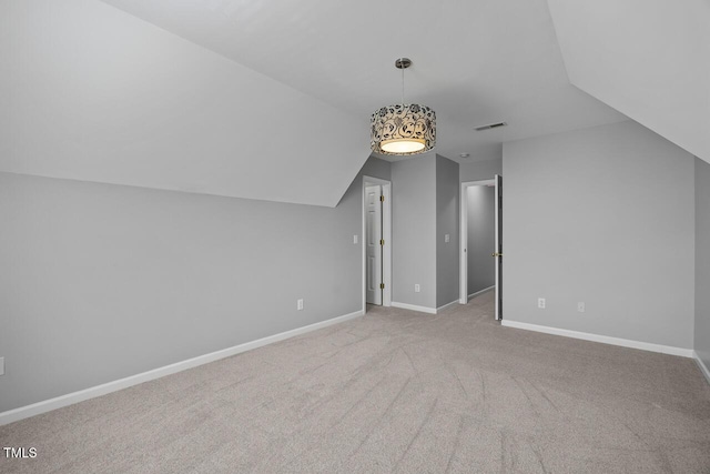 additional living space featuring carpet, lofted ceiling, visible vents, and baseboards