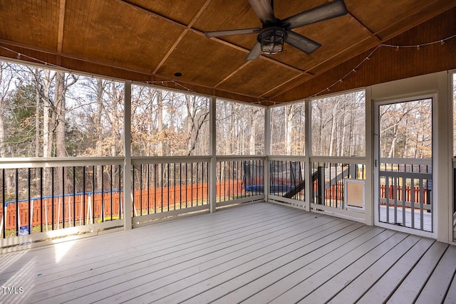 unfurnished sunroom featuring a ceiling fan