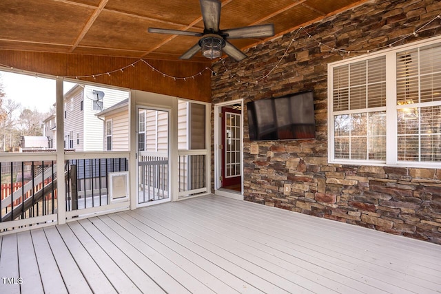 wooden terrace with a ceiling fan