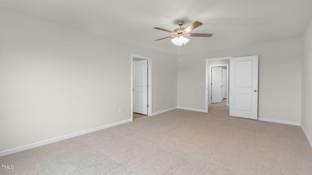 unfurnished bedroom with ceiling fan, baseboards, and light carpet