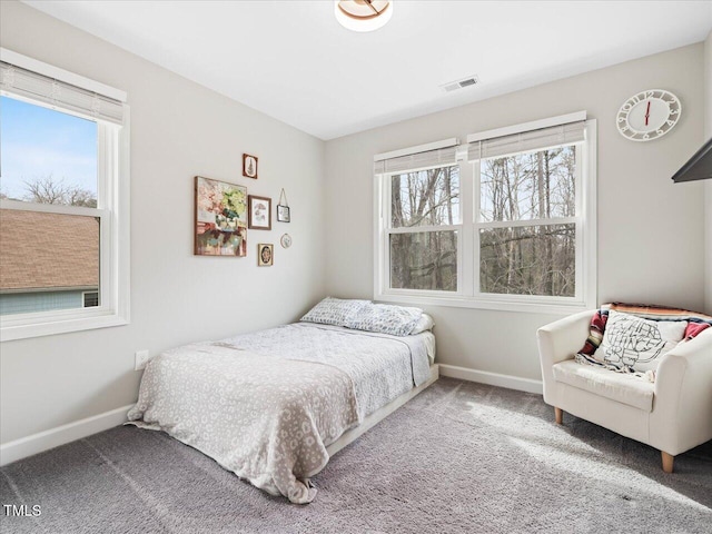 carpeted bedroom with visible vents and baseboards