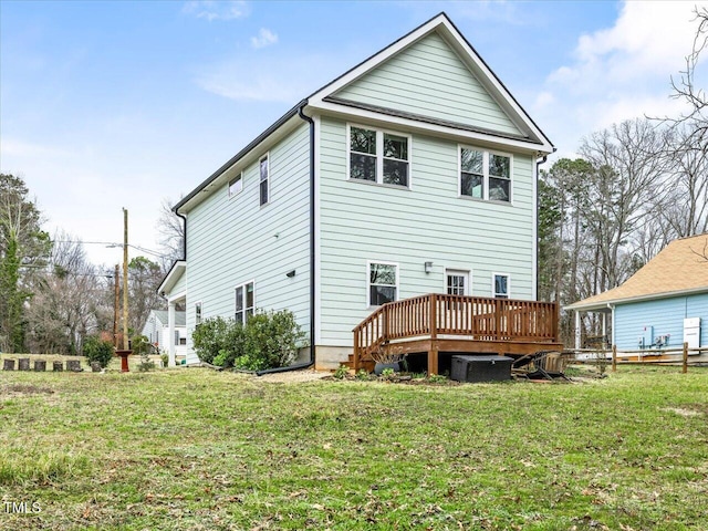 back of property featuring a lawn, central AC, and a deck