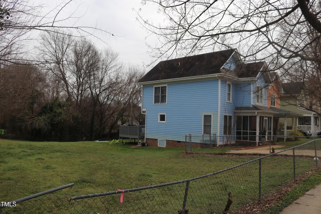 view of side of home featuring a yard and a fenced backyard