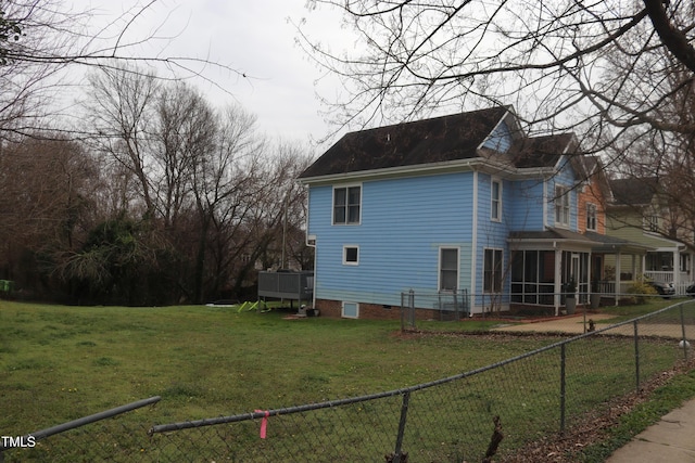 view of side of home featuring a yard and a fenced backyard