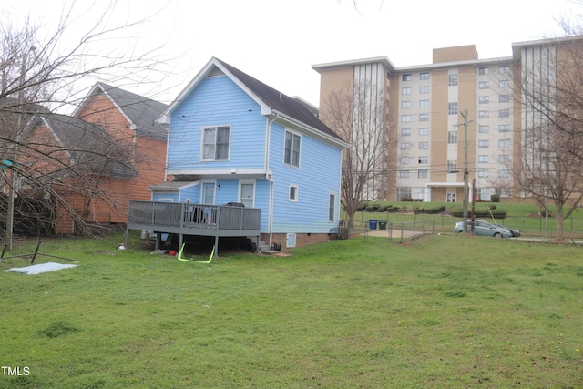 back of house featuring crawl space, a lawn, a deck, and fence