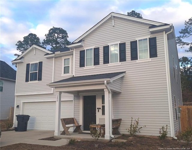 traditional-style house featuring a garage and driveway