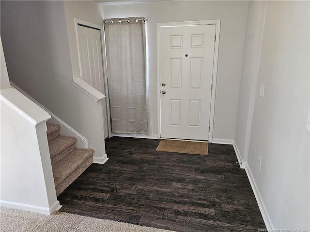 entrance foyer with stairway, baseboards, and dark wood-style flooring