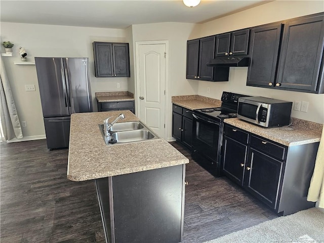 kitchen featuring dark wood-style floors, a sink, stainless steel appliances, light countertops, and under cabinet range hood