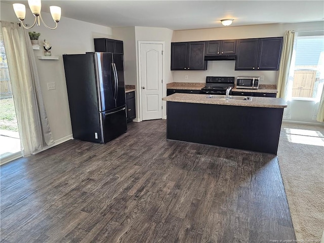 kitchen featuring a sink, light countertops, dark wood-style floors, and stainless steel appliances